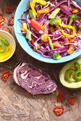 Salad of red cabbage, pieces of grilled chicken, sweet peppers, avocado, tomato