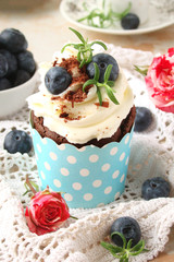 Cupcake with chocolate cream cheese, blueberry, chocolate chip and mint leaves