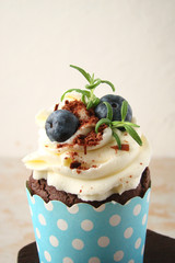Cupcake with chocolate cream cheese, blueberry, chocolate chip and mint leaves