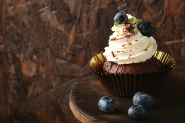 Cupcake with chocolate cream cheese, blueberry, chocolate chip and mint leaves