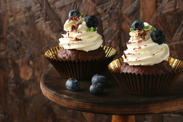 Cupcake with chocolate cream cheese, blueberry, chocolate chip and mint leaves