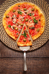 Pizza with tomatoes, mushrooms, black olives, Parmesan cheese, capers