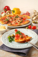 Pizza with tomatoes, mushrooms, black olives, Parmesan cheese, capers