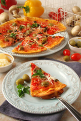 Pizza with tomatoes, mushrooms, black olives, Parmesan cheese, capers
