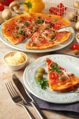 Pizza with tomatoes, mushrooms, black olives, Parmesan cheese, capers