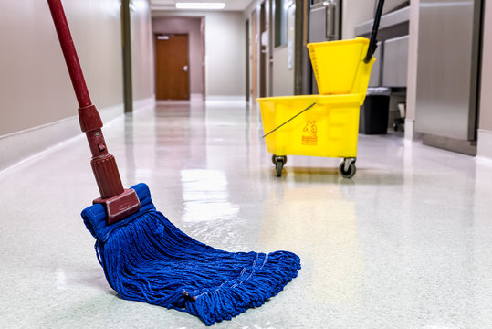 Mopping Wet Floor In Hallway