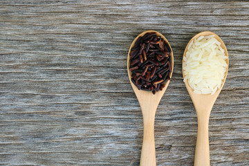 Riceberry and Jasmine rice in wooden spoon.