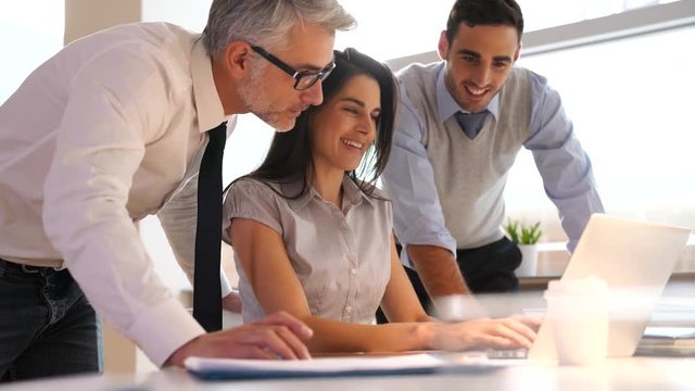 Cheerful business team being happy at receiving good news