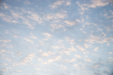 Cloudy sky at sunrise for background. A lot of torn clouds .