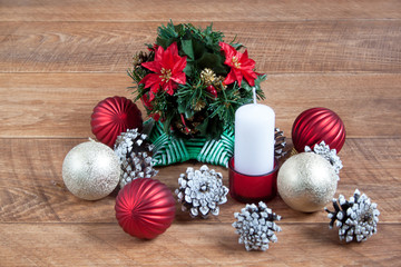 Christmas and New Year decorations are lying on a wooden desk.