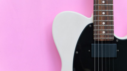 Fototapeta premium Detail of Electric Guitar on a pink background.