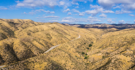 Panorama of road through rolling hills of southern California's Angeles National Forest.