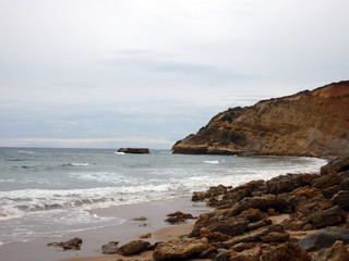 Fototapeta na wymiar Cloudy day rocky sea shore