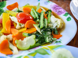 mixed vegetable stire-fried with Tomatoes, carrots, chinese kale, cabbage, cauliflower, pumpkin, paprika