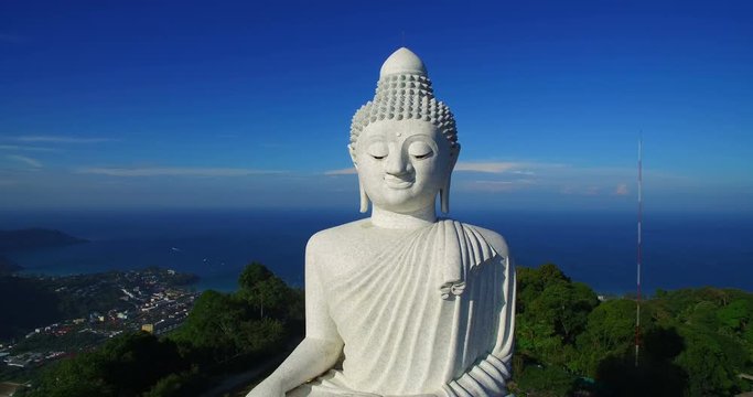 aerial photography blue sky and blue ocean are on the back of Phuket Big Buddha statue. Phuket big Buddha the land mark of Phuket.every day a lot  of tourists come here for look around 360 degree view