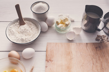 Baking ingredients on rustic wood background