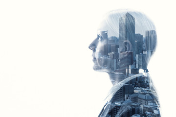 Double exposure of businesswoman and cityscape.