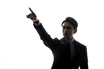 silhouette of businessman pointing to the sky.