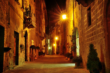 Night view of a characteristic narrow street in Pienza, Tuscany, Italy