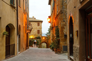 Pienza village characteristic narrow street view at sunrise, Tuscany, Italy