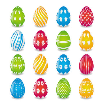 set of eggs painted in  yellow, blue, red and green colors with white patterns