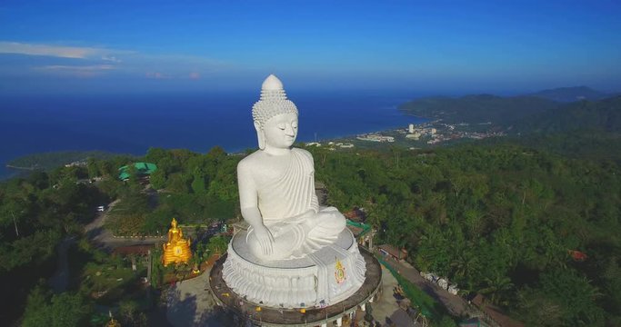 aerial photography blue sky and blue ocean are on the back of Phuket Big Buddha statue. Phuket big Buddha the land mark of Phuket.every day a lot  of tourists come here for look around 360 degree view