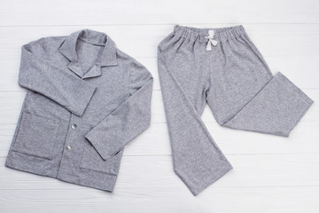 Boys' pajama set on white. Soft gray melange cotton. Loose-fitting shirt and pants for comfort rest...
