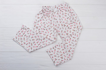 White pajama pants with floral print. Girlish style and lightweight cotton. Warm and cozy sleep.