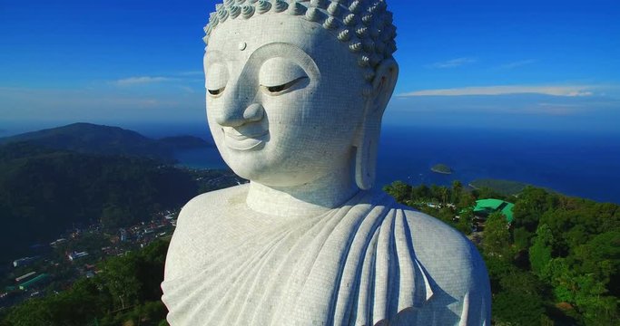 aerial photography blue sky and blue ocean are on the back of Phuket Big Buddha statue. Phuket big Buddha the land mark of Phuket.every day a lot  of tourists come here for look around 360 degree view