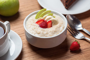 Oat  porridge with strawberry, banana and apple lifestyle.