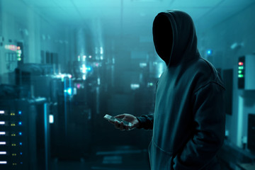 Hacker holding mobile phone © fotokitas