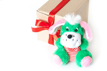 Toy puppy and gift box tired with red ribbon, festive packaging mockup