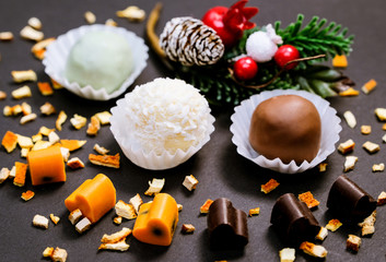 Christmas background: truffles, chocolate hearts and dried orange peel