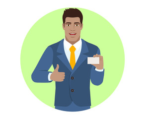 Businessman showing thumb up and showing the business card