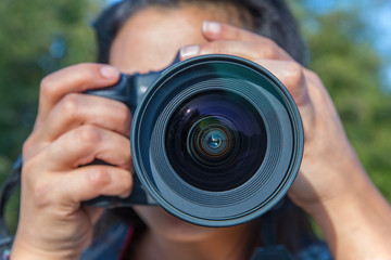 Close up woman photographing with camera