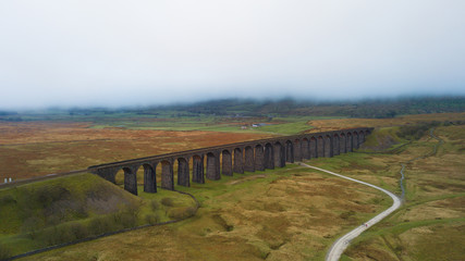 Naklejka premium Aerial View of Train passing over the Ribblehead Viaduct Settle-Carlisle Railway, North Yorkshire