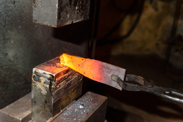 Forging molten metal. Making knives.