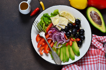  healthy vegetarian plate with avocado, brie cheese, olives and pepper. Lunch.