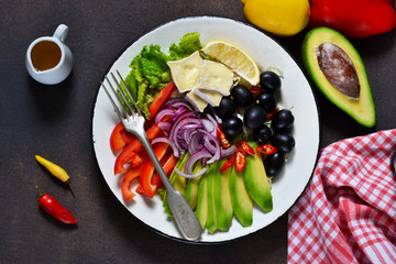  healthy vegetarian plate with avocado, brie cheese, olives and pepper. Lunch.