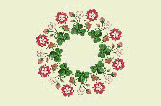 Oval frame of beads and ornament for embroidery of bouquets flowers and clover leaves on light green background

