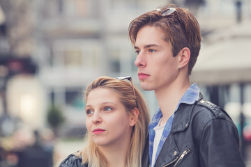 Cute young couple posing outdoors on the street.