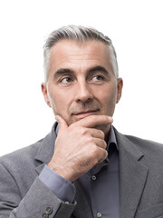 Smart businessman thinking with hand on chin