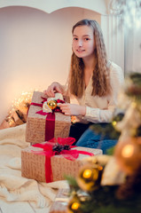 Teenage girl opening the present