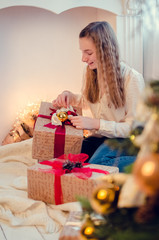 Teenage girl opening the present