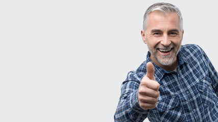 Cheerful man giving a thumbs up