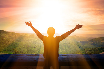 Men hold their arms up, pray to God.