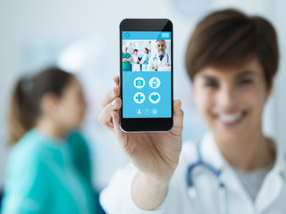 Female doctor holding a smartphone