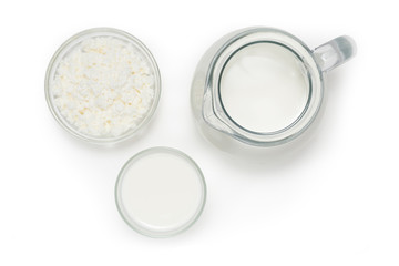 Jug with milk, a glass with yogurt and bowl of cottage cheese on
