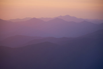 Natural background with ultraviolet mountains after sunset