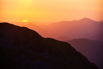Beautiful sunset or sunrise in mountains in yellow orange and ultraviolet colours